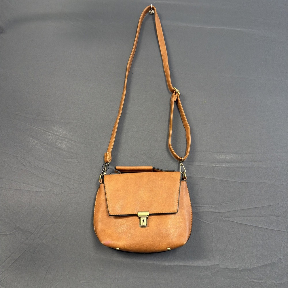 tan leather crossbody bag features a gold-toned turnkey lock closure